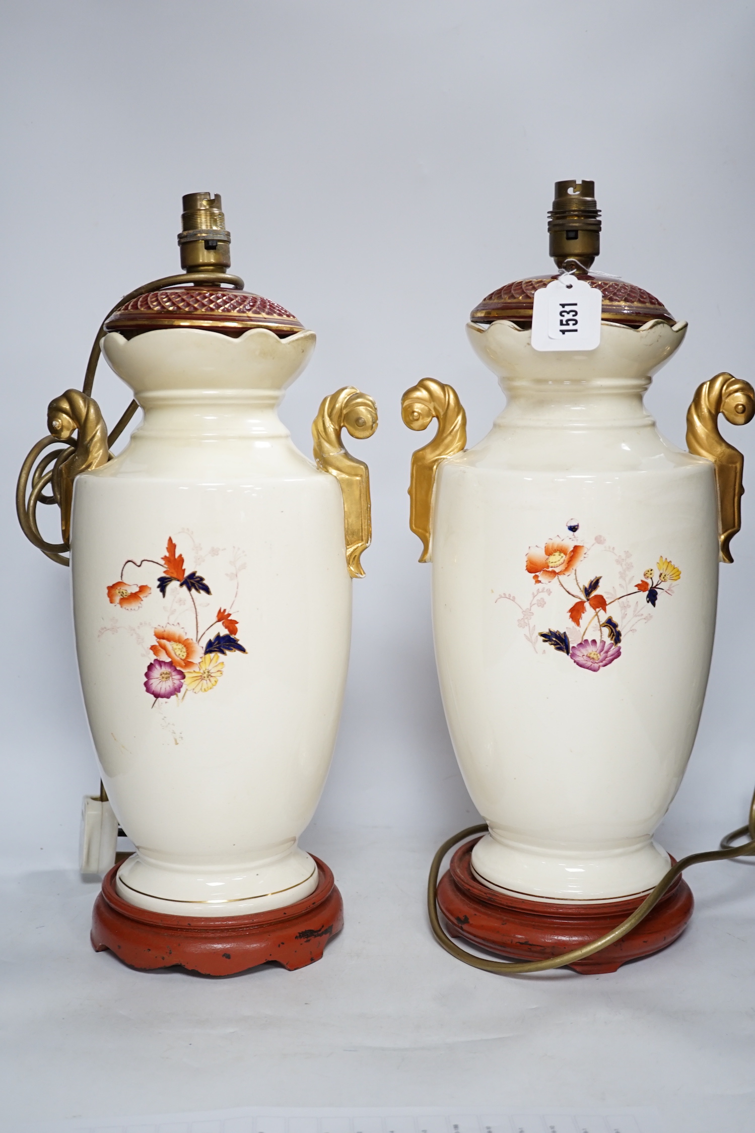 A pair of early 20th century vases mounted as table lamps, hand painted with flowers, 45cm high